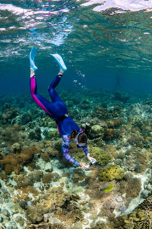 Snorkeler freediving to get a photo in Indonesia
