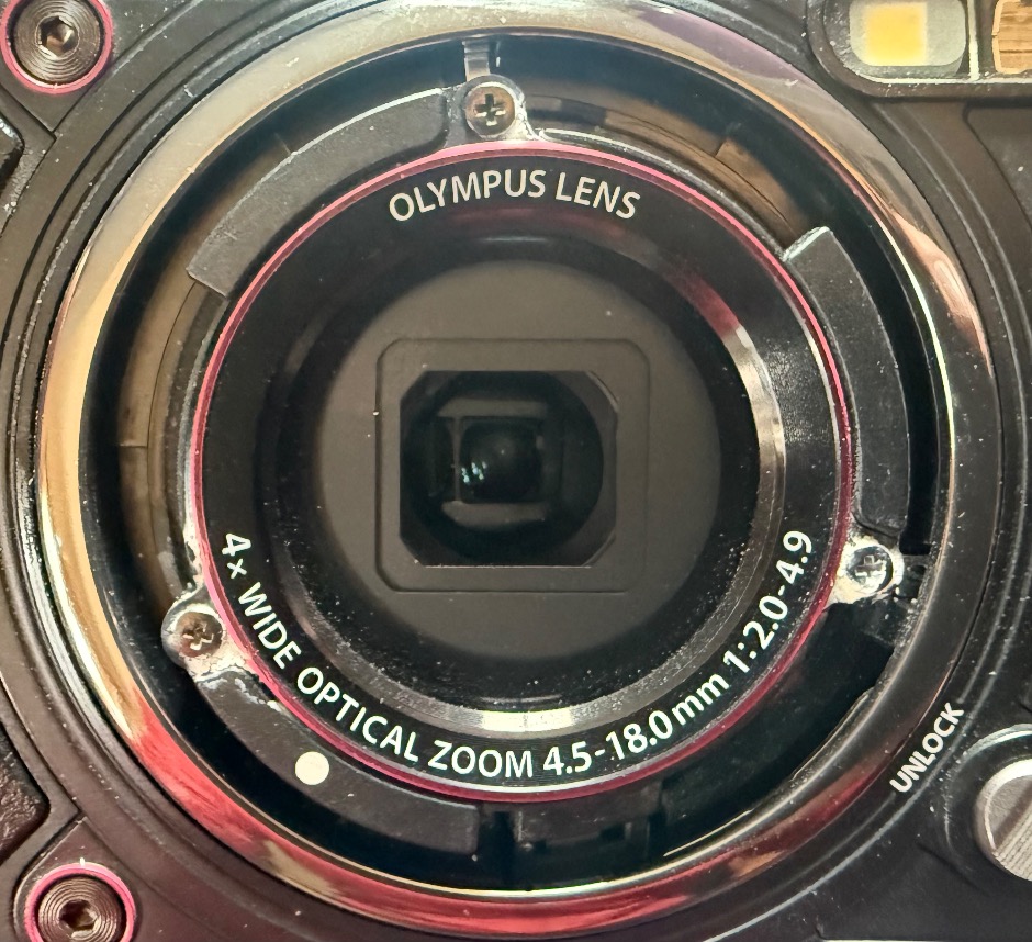 Corrosion on screw around lens on Olympus TG-5 camera